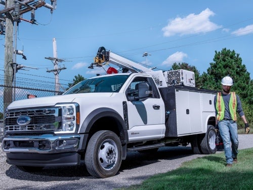 2024 Ford Chassis Cab upfitted as an electrical truck parked by powerlines