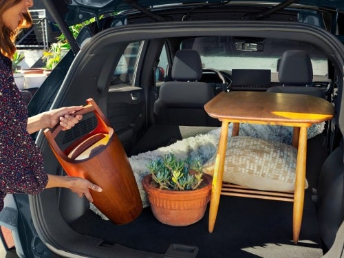 2024 Ford Escape view of woman loading things into cargo area