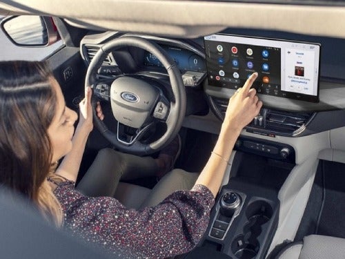 2024 Ford Escape Plug-in Hybrid view of woman in driver seat using touchscreen