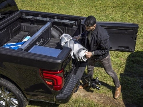 2024 Ford F-150 view of man getting supplies out of bed of truck