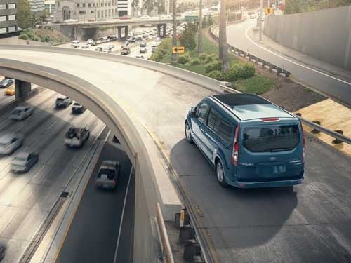 2023 Ford Transit Connect Passenger Wagon traveling down a ramp on the interstate
